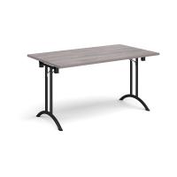 Rectangular folding leg table with black legs and curved foot rails 1400mm x 800mm - grey oak