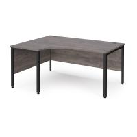 Maestro 25 left hand ergonomic desk 1600mm wide - black bench leg frame, grey oak top