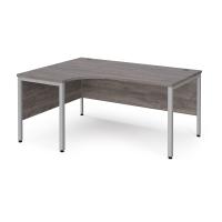 Maestro 25 left hand ergonomic desk 1600mm wide - silver bench leg frame, grey oak top
