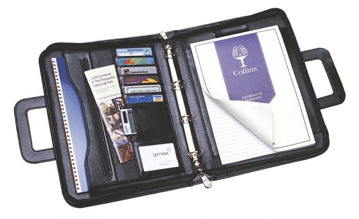 14109CS | 4-Ring Binder. Smooth black leather look A4 conference binder with four-ring mechanism and secure zip closure. Features retractable handles, document zipped pocket, multiple business card holder, pen loop, expandable document pocket and A4 feint ruled pad. WxH: 275x377mm. Capacity: 60mm. Black.