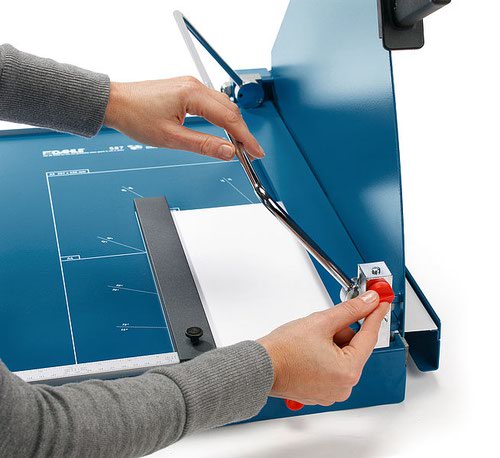 The Dahle 519 A2 Guillotine is a High-quality guillotine for commercial use. Pressed steel blade. Two scale bars with mm scale for an exact 90° cut, this guillotine is ideal for the office.The Dahle 519 guillotine is ideal for a variety of tasks and materials. The shearing action of the knife style blade produces a precise, neat cut every time. This Dahle Guillotine also features a Stay-down D-bar clamp which holds the paper being cut perfectly in place, the adjustable, screw-fastening backstop can be used to quickly find the right format – and can be used on both scale bars.Technical Specification:Cutting length in mm - 700 MaxPaper size in DIN – A2Paper thickness - 70 g/m²Cutting capacity per run 70 g/m² in sheets - 35Scaling in cm