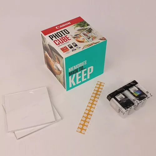 CAN5225B017 | The Photo Cube is a great way to store and display your favourite photos. Small enough to place around your home, you can store your most precious photos inside the box, display the photos on the outside of your box or gift the box to family and friends. You can also use the supplied double-sided tape to decorate the box. The box measures 14 x 14 x 14 cm (approximate), which allows for plenty of space for printed images. The square format is great for social media format printing, making this a great choice for family and friends. This pack is supplied with Genuine Canon PG-540 Black Ink Cartridges, CL-541 C/M/Y Colour Ink Cartridges and 40 5x5” (13 x 13 cm) sheets of square Photo Paper Plus Glossy II, allowing you to get more creative with your printing.