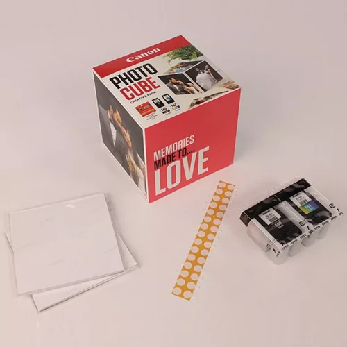 CAN3713C011 | The Photo Cube is a great way to store and display your favourite photos. Small enough to place around your home, you can store your most precious photos inside the box, display the photos on the outside of your box or gift the box to family and friends. You can also use the supplied double-sided tape to decorate the box. The box measures 14 x 14 x 14 cm (approximate), which allows for plenty of space for printed images. The square format is great for social media format printing, making this a great choice for family and friends. This pack is supplied with Genuine Canon PG-560 Black Ink Cartridges, CL-561 C/M/Y Colour Ink Cartridges and 40 5x5” (13 x 13 cm) sheets of square Photo Paper Plus Glossy II, allowing you to get more creative with your printing.