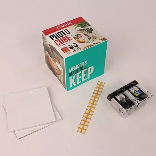 CAN3713C012 | The Photo Cube is a great way to store and display your favourite photos. Small enough to place around your home, you can store your most precious photos inside the box, display the photos on the outside of your box or gift the box to family and friends. You can also use the supplied double-sided tape to decorate the box. The box measures 14 x 14 x 14 cm (approximate), which allows for plenty of space for printed images. The square format is great for social media format printing, making this a great choice for family and friends. This pack is supplied with Genuine Canon PG-560 Black Ink Cartridges, CL-561 C/M/Y Colour Ink Cartridges and 40 5x5” (13 x 13 cm) sheets of square Photo Paper Plus Glossy II, allowing you to get more creative with your printing.