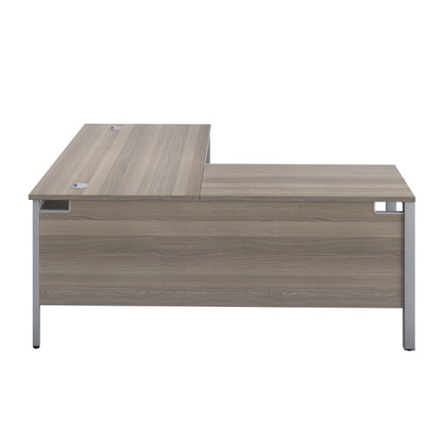 GP1680LHRETGOSV | The Goal Post Left Hand Return Desk is the perfect addition to any modern office space. With its ultra-modern goalpost leg design and modesty panel, this return style desk is both stylish and functional. The secure and sturdy frame ensures long-lasting use, while the durable and well-joined tops provide a timeless finish. The 25mm top thickness adds to the desk's durability and strength. This desk is perfect for those who want a sleek and modern look in their workspace, without sacrificing functionality or durability. Invest in the Goal Post Left Hand Return Desk for a stylish and practical addition to your office.