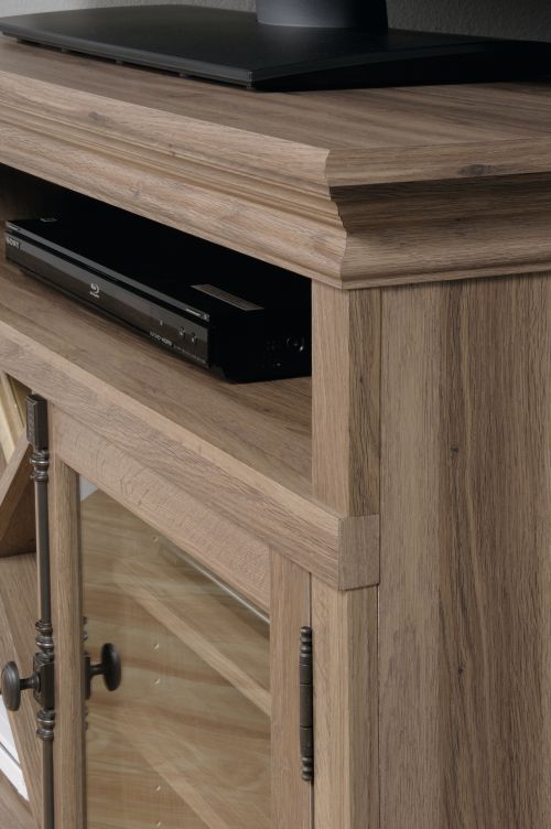 5414729 | The Teknik Office Barrister Home Corner TV Stand in a Salt Oak finish is a perfect solution for those tight spaces around your home! This clean, classy and sturdy stand provides a spacious platform that can hold up to a 42in TV, as well as two adjustable shelves that can house a miscellany of audio/video equipment. It has a salt oak finish framed, safety-tempered glass door with an elegant contrasting black metal handle which protects the shelves and in addition to that, it also boasts a stylish removable criss cross storage rack. The top of the stand houses an internal long open shelf, making it ideal for those binge watching marathons and gamers alike! The useful enclosed back panel with cord access enables simplicity and neatness as does the neutral coloured Salt Oak finish, ensuring it's an ideal match for all rooms and colour schemes. There are also co-ordinating furniture items under the Barrister Home Range that will complement this TV Stand.