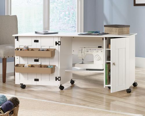 29294TK | The Teknik Office Sewing / Craft Cart in a Soft White Finish is the delightfully simple office furniture offering ideal for any office or room in the house. The generous melamine work surface provides ample space for all of your crafting activities and is highly resistant to heat, stains and scratches, it also extends out and is supported by the main doors using easy roll castors for ease of movement and additional working space. The storage behind these main doors includes two storage bins and a discreet hidden shelf for your sewing machine. There are also two adjustable shelves behind the smaller door for even more storage for your hobby or activity.