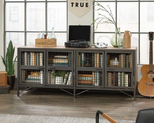 The Teknik Office Boulevard Cafe Industrial Styled Sideboard in Vintage Oak effect and black accents is our decorative and minimalist design option for any room in the home.  This 'Loft apartment' style sideboard has stylish mesh detail and a powder coated metal frame for durability. The large adjustable shelf behind the metal and mesh doors offer flexible storage options. The enclosed back has cord access which allows a convenient and neatly enclosed path for all of your audio/hardware including your DVD player, games console and accessories. This durable yet sleek looking TV Stand provides a spacious platform that can hold up to a 70" TV weighing up to 31kg. The neutral colours ensure it's an ideal match for all rooms and colour schemes. There are also co-ordinating furniture items under the Boulevard Cafe Range that will complement this TV Stand.