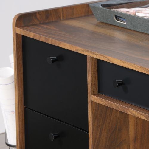 The Teknik Office Hampstead Park Desk is our stylish and minimalist design option for any home office or study. Its spacious work surface offers a perfect storage solution for all your office essentials and work items. This larger yet snappy looking desk features an easy gliding pencil drawer and two file drawers with full extension slides to accommodate letter-size hanging files, a fixed side shelf and last but not least, an adjustable storage shelf discreetly hidden behind a door. Beautifully finished in a Grand Walnut effect with black accents and powdercoated metal base, this modern desk is just what your office has been missing! It also has the added benefit of being finished throughout so you can place the desk freestanding in any location and at any angle. Also ideal to match in this range are the Narrow Bookcase, Compact Desk, and Storage Stand, all finished in the same quintessential style.