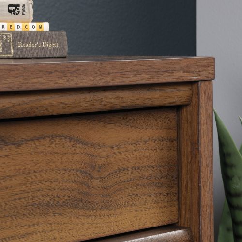 The Teknik Office Clifton Place Storage Side Cupboard is a charming and delightfully neutral coloured option for all styles of office and colour schemes. This mid century styled sideboard offers a multitude of storage options for your home or work space. It benefits from a spacious storage drawer that opens and closes on smooth full extension slides, a roomy adjustable shelf discreetly hidden behind double doors for all your papers, folders and accessories. This also features a grommet hole and pass-through so you can keep all your cords and wires neatly out of the way. You can also add the matching Clifton Place Sideboard Hutch to increase the versatility and space for all of your storage needs! Beautifully finished in a Grand Walnut effect with solid wooden feet, this storage sideboard will blend effortlessly within your home. This also benefits from a 360 degree finish, with the option to be freestanding. Also ideal to match in this range are the Executive Desk, Lateral Filer, Sideboard Hutch, Credenza and L-Shaped Desk, all finished in the same quintessential style