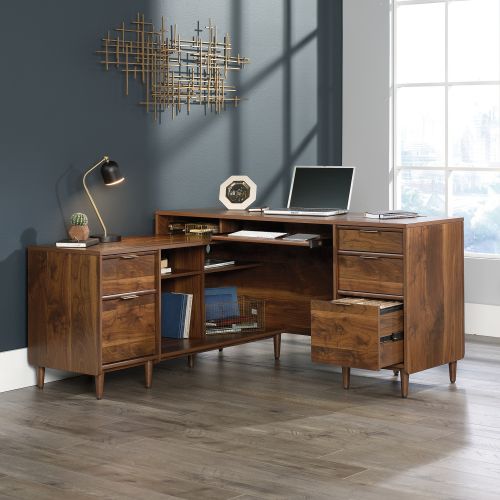The Teknik Office Clifton Place L-Shaped Executive Desk is the charming and delightfully neutral coloured option for those that need the full office solution for their home office without taking up all the room! This mid century styles piece offers a slide out keyboard/mouse shelf that opens and closes on smooth metal runners, three easy gliding storage drawers and two file drawers with full extension slides that accommodate letter-size hanging files. It also features cubbyhole storage so you can access all of your books and folders. Space is no issue with this desk! The large desktop and return provides a generous working area for all types of work as well as there being access to cable ports and pass through openings for discreet cable management. The return can also be fastened on to the left or right side to fit the needs of any room in your home, which is ideal for all styles and colour schemes. Beautifully finished in a Grand Walnut effect with solid wooden feet, this storage sideboard will blend effortlessly within your home. This also benefits from a 360 degree finish, with the option to be freestanding. Also ideal to match in this range are the Executive Desk, Storage Sideboard, Credenza and Lateral Filer, all finished in the same quintessential style