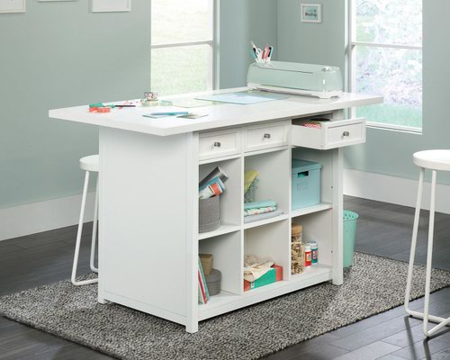 29322TK | The Teknik Office Craft Work Table / Island in a Soft White finish is the delightfully simple office furniture offering ideal for any office or room in the house. The generous melamine work surface provides ample space for all of your crafting activities and is highly resistant to heat, stains and scratches. There are three spacious storage drawers which can be pulled out from either side of the table for versatility and easy access to your accessories. These drawers can also be removed to be used as trays for any hobby or activity you can think of! The item is completed with six identical cubbyholes, perfect for all of your hobby or office storage. This item also has a 360 degree all round finish, ideal for perfect placement within your workspace. 