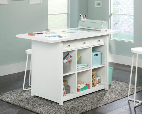29322TK | The Teknik Office Craft Work Table / Island in a Soft White finish is the delightfully simple office furniture offering ideal for any office or room in the house. The generous melamine work surface provides ample space for all of your crafting activities and is highly resistant to heat, stains and scratches. There are three spacious storage drawers which can be pulled out from either side of the table for versatility and easy access to your accessories. These drawers can also be removed to be used as trays for any hobby or activity you can think of! The item is completed with six identical cubbyholes, perfect for all of your hobby or office storage. This item also has a 360 degree all round finish, ideal for perfect placement within your workspace. 