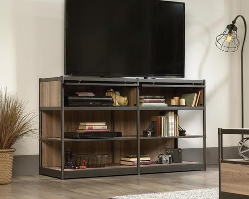 5421458 | The Teknik Office Barrister Home TV Stand / Credenza is a perfect accompaniment for the bedroom, study or living room in your home.  It offers a clean, classy yet sturdy storage space for not just your audio and visual accessories but for all manner of decorative items, pictures frames and books. It features two frame safety-tempered glass doors which flip up and slide neatly back into the credenza for easy access to your hardware as well as four open shelves for additional storage. The enclosed back with pass through opening is perfect for discreet cable management. This TV Credenza also benefits from a durable powder coated metal frame for increased durability. The Salt Oak finish of this bookcase make this an ideal and neutrally coloured match for all colour schemes. There are also co-ordinating furniture items under the Barrister Home Range that will complement this TV Stand/ Credenza.