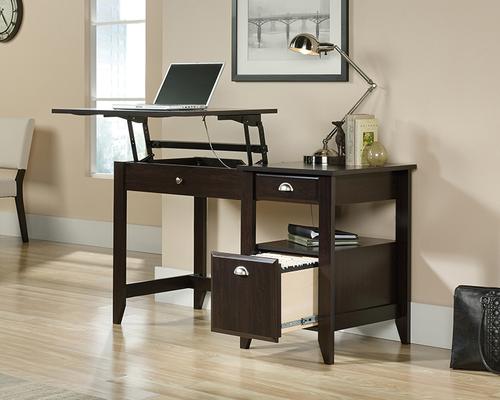 The Teknik Office Sit Stand Desk in a stylish Jamocha Wood effect finish is an ideal fit which will complement all home office colour schemes.  This fresh and modern styled desk benefits from a large working surface in which provides ample space for writing and computer work. The left side of the desktop lifts up and forward to create a versatile option for those that prefer to stand at their desk, which in turn will increase productivity!  Other features of this desk include a hidden storage area beneath the top, lower filing drawer with full extension slides for letter sized hanging files, a storage/stationery drawer and an open shelf for display and essential easy to grab stationery items.  This desk also benefits for quick and easy assembly with patented T-lock drawer system. The 360 degree finishing on all sides completes this adaptable sit/stand desk, the perfect option for any room in your home.