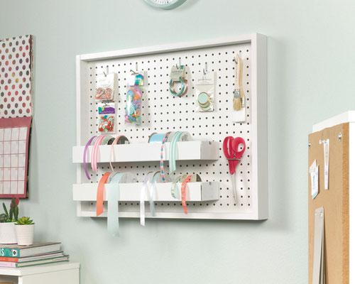 The Teknik Office Craft Wall Mounted Peg Board in a White Finish is a versatile and simple home and craft office furniture which offers an ideal storage solution for all manner of craft supplies. It mounts to the wall so it won't take up any space in your craft area and it is specifically designed to keep all of your craft tool and supplies organised and within easy reach. The removable trays feature a rod for ribbon or thread storage and can be moved around the peg board to suit your organisation. The rods can also be removed from both trays to offer even more flexible craft storage solutions.