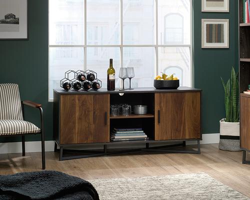 5425302 | The Teknik Office Canyon Lane TV Stand in Brew Oak finish and Grand Walnut accents is the versatile and stylish choice for any living or working area. This item can accommodate up to a 60 inches and if you didn't wish to use it for this, it is versatile enough for use as a display unit or credenza, providing a perfect space for your living room displays, wine racks and your favourite houseplant or five!  This simple and modern TV Stand has three adjustable shelves for even more flexibility and two of these can be hidden behind sliding doors. The enclosed back cut-outs allow a convenient path for cables / cords and the black powder coated metal base ensures increased stability and durability.