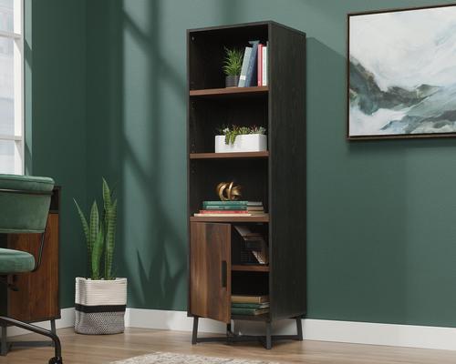 The Teknik Office Canyon Lane 3 Shelf Bookcase with a door in Brew Oak finish with Grand Walnut Accents is the versatile and stylish choice for any living or working area. This bookcase provides a perfect space for your office or home accessories, books and your favourite ornaments. It has three sturdy 1 inch thick height adjustable shelves to allow for awkward sized items and this also benefits from a black powder coated metal base for increased stability. There is additional hidden storage discreetly placed behind a door which can be assembled to open either to the left or right. This also has a matching desk and coffee table.