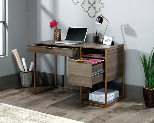 The Teknik Office Lux Desk in Diamond Ash finish is a great retro styled option for any study area of your home. This charming desk benefits from a generous work area, perfect for your laptop, work lamp and favourite coffee cup. It has a pencil drawer with metal runners and safety stops as well as convenient cubbyhole storage. Th desk is completed with a lower filing drawer with full extensions slides which can hold letter or legal size hanging files. The light brown durable powder coated metal frame complements the Diamond Ash finish perfectly, ensuring it's an ideal and seamless match for all rooms and colour schemes. 