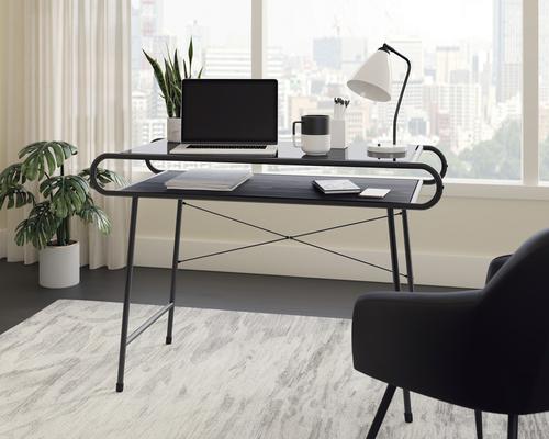 The Teknik Office Metro Home Desk is our spacious and minimalist design option for the home office. This durable yet impressive desk provides a spacious work area for all manner of home office study. The neutral and sturdy black powder coated metal frame coupled with the safety tempered black glass in Misted Elm finish desk top ensure it's an ideal match for all rooms and colour schemes. It has open storage beneath the desk top to stow away all your stationery neatly and also has the added benefit of having a 360 degree all round finish so you can place the desk freestanding in any location and at any angle