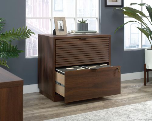 The Teknik Office Elstree Lateral Filer is an ideal option for those that need a stylish office solution for their home office.  With its louvre-style detailing and finished in a stunning spiced mahogany effect, you can be sure of an ideal match for all decorative interior and tastes. It has two lockable drawers to ensure your documents are kept secure while the patented safety mechanism allows only one drawer to open at a time. Both filing drawers feature full extension slides to hold letter or legal size hanging files. The generous top surface provides additional space for storage of your display items. This filer has a patented T-lock drawer system which makes for a quick and easy assembly. It also has a 360 degree finish, for effortless and versatile placement anywhere within your home or office working area. 