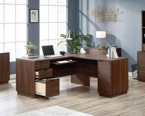 12767TK | The Teknik Office Elstree L-Shaped Desk is an ideal option for those that need the full office solution for their home office without taking up all the room! This louvre-style detailed desk has a large desktop and return working surface finished in a stunning spiced mahogany effect which not only provides more than ample space for writing and computer work, it is an ideal match for all decorative interiors. There are three storage drawers with metal runners and safety stops to stash all manner of desking stationery as well as an additional storage area with an adjustable shelf discreetly hidden behind a door which is a perfect size to hold a vertical CPU tower. This desk also benefits from a slide out keyboard/mouse shelf that can be fixed in three different positions as well as a lockable lower filer drawer which can hold your important letter or legal sized hanging files. . There is also a grommet hole for discreet cable management. This desk also benefits from a 360 degree finish, for effortless and versatile placement anywhere within your home or office working area.