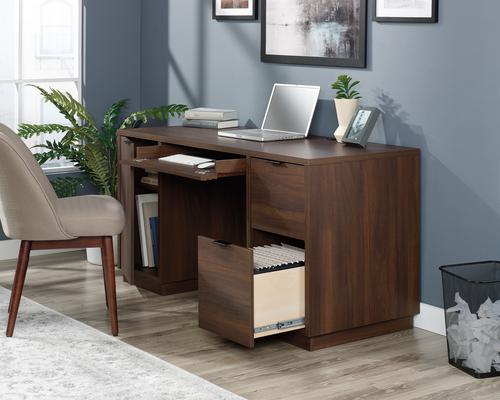 12753TK | The Teknik Office Elstree Double Pedestal Desk is an ideal option for those that need a stylish office solution for their home office.  This louvre-style detailed desk has a generous sized working surface finished in a stunning spiced mahogany effect which not only provides more than ample space for writing and computer work, it is an ideal match for all decorative interiors. There are three storage drawers with metal runners and safety stops to stash all manner of desking stationery as well as an additional storage area with an adjustable shelf discreetly hidden behind a door which is a perfect size to hold a vertical CPU tower. This desk also benefits from a large drawer/shelf on metal runners that feature a flip down panel for your keyboard/mouse. This desk also has a lower filer drawer which can hold your important letter or legal sized hanging files.  There is also a grommet hole for discreet cable management. This desk also benefits from a 360 degree finish, for effortless and versatile placement anywhere within your home or office working area.
