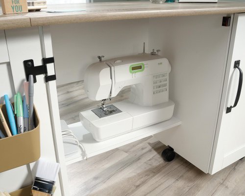 The Teknik Office Sewing / Craft Cart in a Soft White Finish with Lintel Oak accents is the delightfully simple office furniture offering ideal for any office or room in the house. The generous melamine work surface provides ample space for all of your crafting activities and is highly resistant to heat, stains and scratches, it also extends out and is supported by the main doors using easy roll castors for ease of movement and additional working space. The storage behind these main doors includes two storage bins and a discreet hidden shelf for your sewing machine. There are also two adjustable shelves behind the smaller door for even more storage for your hobby or activity. 