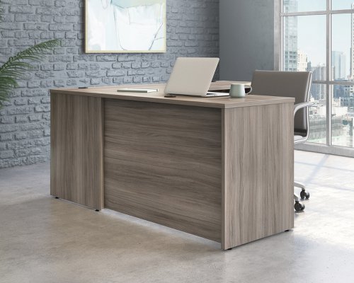25871TK | The Teknik Office Affiliate Return Unit is our functional and commercial style option for all manner of colour schemes and work spaces.  This return desk offers a very durable 1” thick melamine heat, stain and scratch resistant top to hold up your laptop, favourite beverage and display items with ease. It comes with a handy grommet hole for easy cord management and the adjustable base feet will ensure it stays perfectly level on even the most uneven floors.  Beautifully finished in a Hudson Elm effect, this Return Unit also benefits from a 360 degree finish for adaptable placement within your office. Please be aware, this is an add-on return unit for extending current Affiliate desking codes: 5427427, 5427422 and 5427468, this can be conveniently placed as either a left or right hand return unit.  There are also other matching cupboards, desks, hutches and bookcases within the Affiliate range which will complement this item.