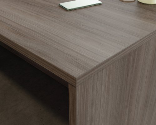 The Teknik Office Affiliate 1800 x 600 Desk is our functional and commercial style option for all manner of colour schemes and work spaces.  This large desk offers a very durable 1” thick melamine heat, stain and scratch resistant top to hold up your laptop, favourite beverage and display items with ease. It comes with two handy grommet holes for easy cord management and the adjustable base feet will ensure it stays perfectly level on even the most uneven floors.  Beautifully finished in a Hudson Elm effect, this Desk also benefits from a 360 degree finish for adaptable placement within your office. It can be used as a stand alone desk or can be fastened to the left or right side of these Affiliate desking codes: to 5427413, 5427427 and 5427468  to extend your work area. There are also other matching cupboards, desks, hutches and bookcases within the Affiliate range which will complement this item.