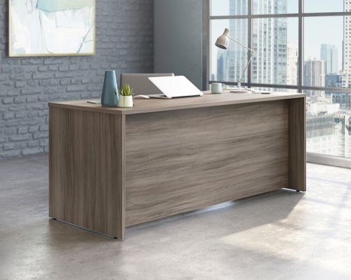 The Teknik Office Affiliate 1800 x 750 Desk is our functional and commercial style option for all manner of colour schemes and work spaces.  This large desk offers a very durable 1” thick melamine heat, stain and scratch resistant top to hold up your laptop, favourite beverage and display items with ease. It comes with two handy grommet holes for easy cord management and the adjustable base feet will ensure it stays perfectly level on even the most uneven floors.   The desk is also impact resistant with its high grade thermoplastic edges. Beautifully finished in a Hudson Elm effect, this Desk also benefits from a 360 degree finish for adaptable placement within your office. There are also other matching cupboards, desks, hutches and bookcases within the Affiliate range which will complement this item.