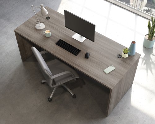 The Teknik Office Affiliate 1800 x 750 Desk is our functional and commercial style option for all manner of colour schemes and work spaces.  This large desk offers a very durable 1” thick melamine heat, stain and scratch resistant top to hold up your laptop, favourite beverage and display items with ease. It comes with two handy grommet holes for easy cord management and the adjustable base feet will ensure it stays perfectly level on even the most uneven floors.   The desk is also impact resistant with its high grade thermoplastic edges. Beautifully finished in a Hudson Elm effect, this Desk also benefits from a 360 degree finish for adaptable placement within your office. There are also other matching cupboards, desks, hutches and bookcases within the Affiliate range which will complement this item.