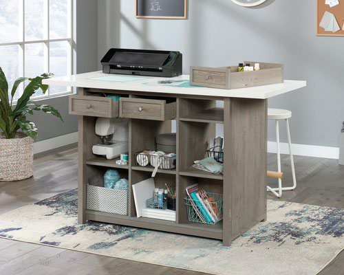 29329TK | The Teknik Office Craft Work Table / Island in a Mystic Oak finish and white accent desktop is the delightfully simple office furniture offering ideal for any office or room in the house. The generous melamine work surface provides ample space for all of your crafting activities and is highly resistant to heat, stains and scratches. There are three spacious storage drawers which can be pulled out from either side of the table for versatility and easy access to your accessories. These drawers can also be removed to be used as trays for any hobby or activity you can think of! The item is completed with six identical cubbyholes, perfect for all of your hobby or office storage. This item also has a 360 degree all round finish, ideal for perfect placement within your workspace. 