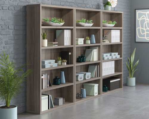 25850TK | The Teknik Office Affiliate 5 Shelf Bookcase is our functional and commercial style option for all manner of colour schemes and work spaces.  This bookcase offers a very durable and efficient solution for creating additional storage for your office needs, keeping your current office clutter free. It has durable, strong but lightweight 1 1/4 inch thick panel construction which means its sturdy to hold your files, books and favourite plants or photo frames but also light enough to move around to the ultimate position in your space.  The three adjustable shelves provide versatility for your display items. Beautifully finished in a Hudson Elm effect, this bookcase also benefits from a 360 degree finish for adaptable placement. There are also other matching cupboards, desks, hutches and bookcases within the Affiliate range which will complement this item.