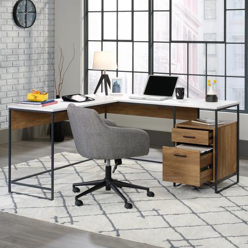 The Teknik Office Moderna L-Shaped Executive Desk is an ideal option for those that need the full office solution for their home office without taking up all the room! It has a Sindoori Mango effect colour with a stylish contrasting desktop and return in white which is an ideal coupling for all colour schemes. The large desktop and return provides a generous working area for all types of work and the two drawers on full extension slides are perfect for discreetly keeping all of your pens, pads and other office accessories neatly hidden. The lower drawer can also hold letter size hanging files. There is also a small open cubby shelf for books and other study items. It also has the added benefit of being finished 360 degrees for multiple placement within your room. All in all, a fabulous solution for all your home office needs.