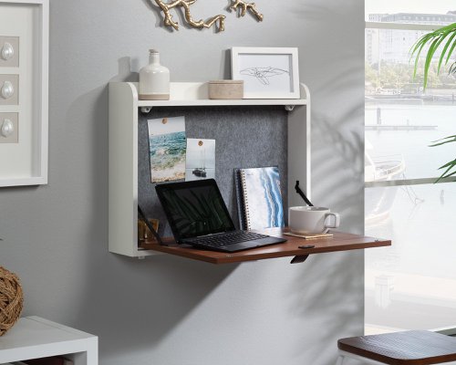 5431222 | The Teknik Office Avon Leather Handled Wall Desk is a charming option for all styles of office and colour schemes.  This fresh and modern styled space saving hanging desk is finished in Pearl Oak and has a flip down door, this provides a convenient solution for those with limited space. This hanging desk is versatile enough to place anywhere in your home or office and the door can be lowered down to create a spacious desk work area for your laptop, office accessories and possibly even a cup of your favourite tea! Once the desk is fully opened, there is also a large contrasting grey bulletin style board in front of you, perfect for pinning your reminders and paperwork in full view for when you need them. An open upper shelf on top of the desk completes the look for displaying all manner of home decor. The look is completed with the front also featuring an unusual yet stunning addition of a drawer pull in durable brown leather for an extra touch of class.  A beautiful and versatile wall desk which will blend effortlessly within your home or working area. 