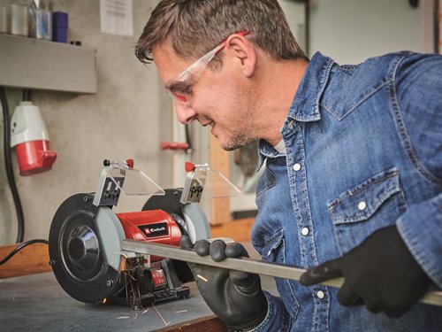 The Einhell TC-BG 150 Bench Grinder is a practical grinding/sanding machine for a wide range of applications. It has two grinding/sanding wheels, each driven by a single motor, is an essential item of equipment in any workshed.A double wheel grinder can be used for sharpening scissors, knives and blades, cutting blades, drill bits and cutters, and even chisels. In addition, the double wheel grinder can also be used for derusting and deburring and for sanding/grinding and polishing a wide range of workpieces made of wood, plastic and metal. The double wheel grinder is specifically suitable for performing minor repairs and sharpening blades, but can also be used for strong repairs, adjustments to shape and new initial grinding/sanding as well.The robust compact metal construction ensures the grinder has a long service life. Large adjustable work supports are a help for a wide range of applications, while the ball bearing mounted shaft with zero play makes it possible to achieve precise results. For safety there are spark guard windows which can be adjusted without any tools, plus guard hoods which are closed at the sides. Four rubber feet absorb vibrations and ensure a secure and steady standing position in operation.Supplied with a coarse and fine grinding/sanding wheel (K36/K60).Specifications:Input Power: 150W.No Load Speed: 2,980/min.Coarse Grinding Disc Diameter: Inner 32mm, Outer 150mm.Fine Grinding Disc Diameter: Inner 32mm, Outer 150mm.Weight: 5.89kg.