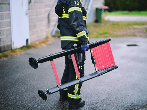 The Telesteps Rescue Line Telescopic Ladder is the first telescopic ladder in the world where 3 people can use the ladder at the same time. It is the 2nd generation with the revolutionary triangular tube design, which makes the ladder stronger and more torsional rigid than ever before.Because of its compact nature, it’s especially useful in narrow spaces, staircases, in elevator rooms, etc. It also fits in any vehicle, being accessible whenever you need it. To save time while extending the ladder in pressured situations, Rescue Line has built-in height indicators, letting you choose the right height for every specific situation.The Rescue Line is certified according to the European standard EN 1147, specifically created for fire and rescue workers. This standard is known as one of the strictest certifications to obtain for a telescopic ladder, means amongst other advantages, it can handle loads up to 500kg or 3 people at the same time.This Telesteps Rescue Line Firefighters Telescopic Ladder has the following specifications:No. of Treads: 13.Tread Width: 50mm.Working Height: 5.0m.Extended Length: 4.1m.Closed Length: 1.17m.Width: 0.47m.Weight: 19.2kg.