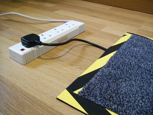 Stop accidents from trailing wires with the innovative Floortex Kablemat. This clever floor mat not only protects your flooring from wear and tear, but also includes a nifty built-in recess for wires and cabling. A smart charcoal rug with an anti-slip rubber backing and clearly visible black and yellow edging to make sure people notice the potential hazard - the Kablemat will ensure safety without detracting from the professional environment.