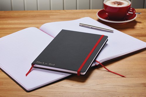 This premium Black n' Red A5 notebook contains 144 pages of quality Optik paper, which is ruled and numbered for neat, indexed notes. The casebound notebook features durable hard covers with a soft touch finish, as well as a red elasticated strap to help keep contents secure. The notebook also features an inside rear pocket for storage of additional loose pages and a ribbon marker for quick and easy reference. This pack contains 1 x A5 notebook.